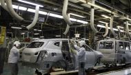 FILE PHOTO: Employees of Nissan Motor Co. work on the assembly line at the company's Kyushu plant in Kanda town, Fukuoka Prefecture, Japan, July 9, 2015. Picture taken July 9, 2015. REUTERS/Maki Shiraki