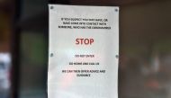 Signs warning patients about the 2019-nCoV strain of the novel coronavirus, are pictured at The County Oak Medical Centre in Brighton, Southern England on February 10, 2020, after it closed for 