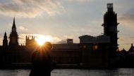 A man stands on the banks of River Thames across from the Houses of Parliament in Westminster in central London on March 27, 2019. AFP / Tolga Akmen
