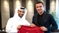 The Secretary-General of the Supreme Committee for Delivery and Legacy, Hassan Al Thawadi presenting a Qatar 2022 jersey to Australian football legend Tim Cahill.