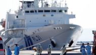 Medical personnel work near the cruise ship Diamond Princess, where dozens of passengers were tested positive for coronavirus, at Daikoku Pier Cruise Terminal in Yokohama, south of Tokyo, Japan, February 11, 2020. REUTERS/Issei Kato