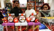 Chocolate products, including jars of a Gazan version of a world-famous spread, dubbed 'Natalia' are displayed on a shop counter in Gaza city on February 12, 2020. AFP / Mohammed Abed 