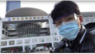 In this image from video taken Feb. 4, 2020 and released by Chen Qiushi, Chinese citizen journalist Chen Qiushi speaks in front of a convention center-turned makeshift hospital amid a viral epidemic in Wuhan in central China's Hubei province.  (Courtesy o