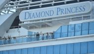 Passengers are seen on the deck of the Diamond Princess cruise ship, with around 3,600 people quarantined onboard due to fears of the new coronavirus, at the Daikaku Pier Cruise Terminal in Yokohama port on February 13, 2020. AFP / Kazuhiro Nogi
 