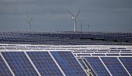 A solar power plant is seen past wind turbines in Canino, central Italy, April 27, 2016. Reuters / Max Rossi