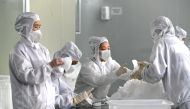 Employees work on a production line manufacturing face masks at a factory, as the country is hit by an outbreak of the novel coronavirus, in Fuzhou, Fujian province, China February 15, 2020. (cnsphoto via REUTERS)