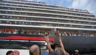  Passengers wave their hands after they depart from MS Westerdam, a cruise ship that spent two weeks at sea after being turned away by five countries over fears that someone aboard might have the coronavirus, as it docks in Sihanoukville, Cambodia Februar