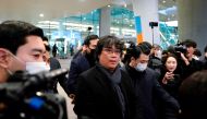 Director of four Oscar award-winning film 'Parasite' Bong Joon-ho is escorted by security personnel as he leaves Incheon International Airport, South Korea, February 16, 2020. REUTERS/Kim Hong-Ji