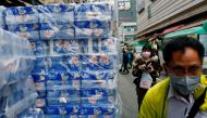 People wear masks as they walk past rolls of toilet paper at a market, following the outbreak of a new coronavirus, in Hong Kong. (REUTERS/Tyrone Siu/File Photo)