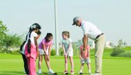 Young golfers receiving tips from a coach as they prepare for the Qatar Schools Golf Championship, scheduled to be held on February 22 at the Education City Golf Club.
