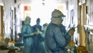 This photo taken on February 16, 2020 shows medical staff members working at the isolation ward of the Wuhan Red Cross Hospital in Wuhan in China's central Hubei province./ AFP / STR 