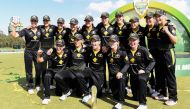 Australian players celebrate with the trophy after defeating India in the final of their women's T20 international tri-series cricket match in Melbourne on February 12, 2020. / AFP / William WEST