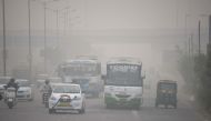In this photograph taken on November 7, 2016 Indian commuters journey along a major road as heavy smog covers New Delhi. AFP
