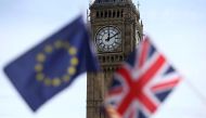 FILE PHOTO: Participants hold a British Union flag and an EU flag during a pro-EU referendum event at Parliament Square in London, Britain June 19, 2016. REUTERS/Neil Hall/File Photo