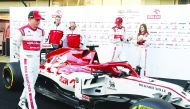 Alfa Romeo's Finnish driver Kimi Raikkonen (L) and Alfa Romeo's Italian driver Antonio Giovinazzi (2R) pose with the new Alfa Romeo Racing C39 Formula One car at the Circuit de Barcelona-Catalunya in Montmelo in the outskirts of Barcelona on February 19, 