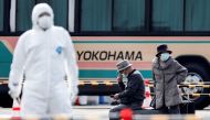 Passengers wait for transportation after leaving the coronavirus-hit Diamond Princess cruise ship docked at Yokohama Port, south of Tokyo, Japan, February 20, 2020. REUTERS/Kim Kyung-Hoon 