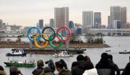 Giant Olympic Rings are installed at the waterfront area, with the Rainbow Bridge in the background, ahead of an official inauguration ceremony, six months before the opening of the Tokyo 2020 Summer Olympic Games, at Odaiba Marine Park in Tokyo, Japan Ja