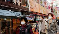 Women wearing masks as a preventive measure against the coronavirus walk at a traditional market in Seoul, South Korea, February 20, 2020. REUTERS/Heo Ran 