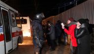 Buses transporting evacuees, who arrived from coronavirus-hit China's Hubei province, drive past demonstrators during a protest against their arrival near a sanatorium in the village of Novi Sanzhary in Poltava region, Ukraine February 20, 2020. REUTERS/V