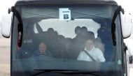 Passengers who have been under quarantine on a coronavirus-stricken cruise ship off the coast of Japan, the Diamond Princess, are seen wearing face masks as they leave RAF Boscombe Down in Amesbury, Britain, February 22, 2020. REUTERS/Henry Nicholls