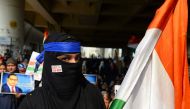 A demonstrator holds an Indian national flag during a protest against the Indian government's Citizenship Amendment Act (CAA) and the National Register of Citizens (NRC) at Jaffrabad area in New Delhi on February 23, 2020. AFP / Sajjad Hussain
 