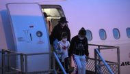 Australian evacuees who were quarantined on Christmas Island over concerns about the coronavirus disembark from a plane at Sydney Airport in Sydney, Australia, February 17, 2020. Picture taken February 17, 2020. AAP Image/Steven Saphore/via REUTERS