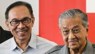 In this file photo taken on June 1, 2018, Malaysia's Prime Minister Mahathir Mohamad (R) and politician Anwar Ibrahim leave after a press conference in Kuala Lumpur. / AFP / Mohd RASFAN 