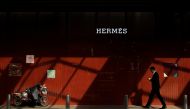 A man walks past a store of luxury goods retailer Hermes one day before the opening session of the National Peoples’ Congress in Beijing, China, March 4, 2019. Reuters / Thomas Peter
 