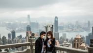People wearing protective face masks visit the lookout of Victoria Peak in Hong Kong on February 25, 2020. AFP / Isaac Lawrence
