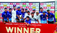 Bangladeshi cricketers pose for photos with the trophy following a presentation ceremony after winning the test match between Bangladesh and Zimbabwe during the fourth day at the Sher-e-Bangla National Cricket Stadium in Dhaka on February 25, 2020. AFP / 