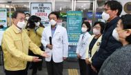 South Korea's President Moon Jae-in gets briefed during his visit to a medical center in Daegu, South Korea, February 25, 2020. Yonhap via REUTERS