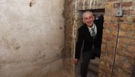 A handout photograph released by the UK Parliament on February 26, 2020, shows Speaker of the House of Commons Lindsay Hoyle visiting secret chamber concealing a 360-year-old blocked passageway rediscovered during renovation work in the Houses of Parliame