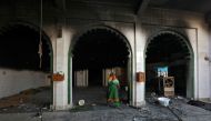 A woman walks inside a partially damaged mosque after it was set on fire by a mob in a riot affected area after clashes erupted between people demonstrating for and against a new citizenship law in New Delhi, India, February 26, 2020. Reuters/Rupak De Cho