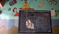 A man is seen through a hole on a classroom wall after the school building was attacked by a mob in a riot affected area following clashes between people demonstrating for and against a new citizenship law in New Delhi, India, February 27, 2020. REUTERS/R