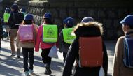  Elementary school students walk toward their school in Tokyo, Japan, February 28, 2020. REUTERS/Issei Kato 