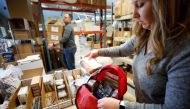 Kristen Curley, owner of Nitro-Pac, puts items into a backpack as part of personal protection and survival equipment kits ordered by customers preparing against novel coronavirus, at Nitro-Pak in Midway, Utah, February 27, 2020. Reuters/George Frey