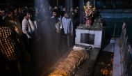 Relatives and friends of Rahul Thakur, 23, who died in this week's sectarian riots in India's capital over Prime Minister Narendra Modi's citizenship law, stand around his body before its cremation in New Delhi February 27, 2020. AFP / Money SHARMA 
 