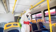 A worker disinfects a public bus against COVID-19, the novel coronavirus, in Skopje on February 29, 2020.  AFP / Robert ATANASOVSKI