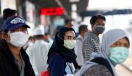 FILE PHOTO: People with surgical masks look on at station Tanah Abang, following the outbreak of the coronavirus in China, in Jakarta, Indonesia February 13, 2020. REUTERS/Ajeng Dinar Ulfiana/File Photo