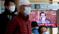People watch a TV broadcasting a news report on a news conference held by Lee Man-hee, founder of the Shincheonji Church of Jesus the Temple of the Tabernacle of the Testimony, in Seoul, South Korea, March 2, 2020. REUTERS/Heo Ran
