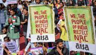 Protesters hold placards during a protest against India's new citizenship law, in New Delhi on March 3, 2020. AFP / Money Sharma 