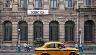 A yellow ambassador taxi drives past the HSBC bank building in Kolkata November 5, 2013. Reuters/Rupak De Chowdhuri