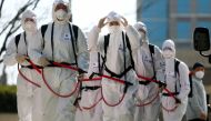 South Korean soldiers wearing protective gear prepare to spray disinfectant as part of preventive measures against the spread of the COVID-19 coronavirus, at city hall in Daegu on March 2, 2020.  AFP / Yonhap