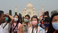 Tourists wearing protective masks are pictured at the historic Taj Mahal in Agra, India, March 3, 2020. REUTERS/Stringer 