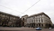 An Italian police car is seen near a mainly deserted Piazza della Scala on February 29, 2020 in center Milan, northern Italy.  AFP / Miguel Medina
 