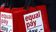 People carry bags reading ‘Equal Pay Day’ during a protest a day before International Women’s Day, in Bern March 7, 2015. Reuters / Ruben Sprich