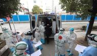  Medical staff assist a patient infected by the COVID-19 coronavirus leaving from Wuhan No.3 Hospital to travel to Huoshenshan Hospital in Wuhan in China's central Hubei province on March 4, 2020. / AFP / STR
