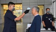 An Indonesian security personal checks the body temperature of a man to entering a building in Jakarta on March 5, 2020. AFP / ADEK BERRY