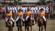 In this photograph taken on January 7, 2020, Thangmeiband Youth Polo Club players line up before their match against Linthoingambi Kangjei Lup polo club during the 15th Women's State Polo Tournament at the Mapal Kangjeibung (Polo Ground) in Imphal, the ca