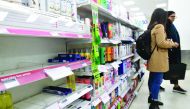 A picture shows a sign, on empty shelves, alerting customers to limited sales of antibacterial hand washes and sanitiser gels, inside a Boots store in London on March 3, 2020.  AFP / Justin Tallis
 